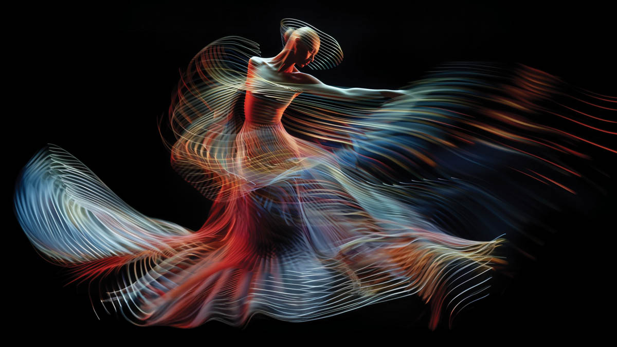 A digital abstract representation of a dancer in motion, with flowing, colorful light trails capturing the dynamic movement.